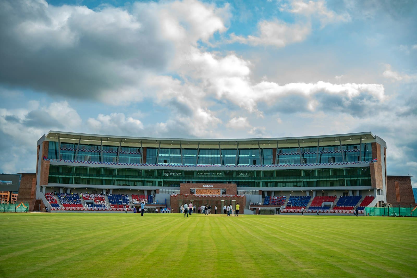 Cricket ground and pavilion under a blue sky