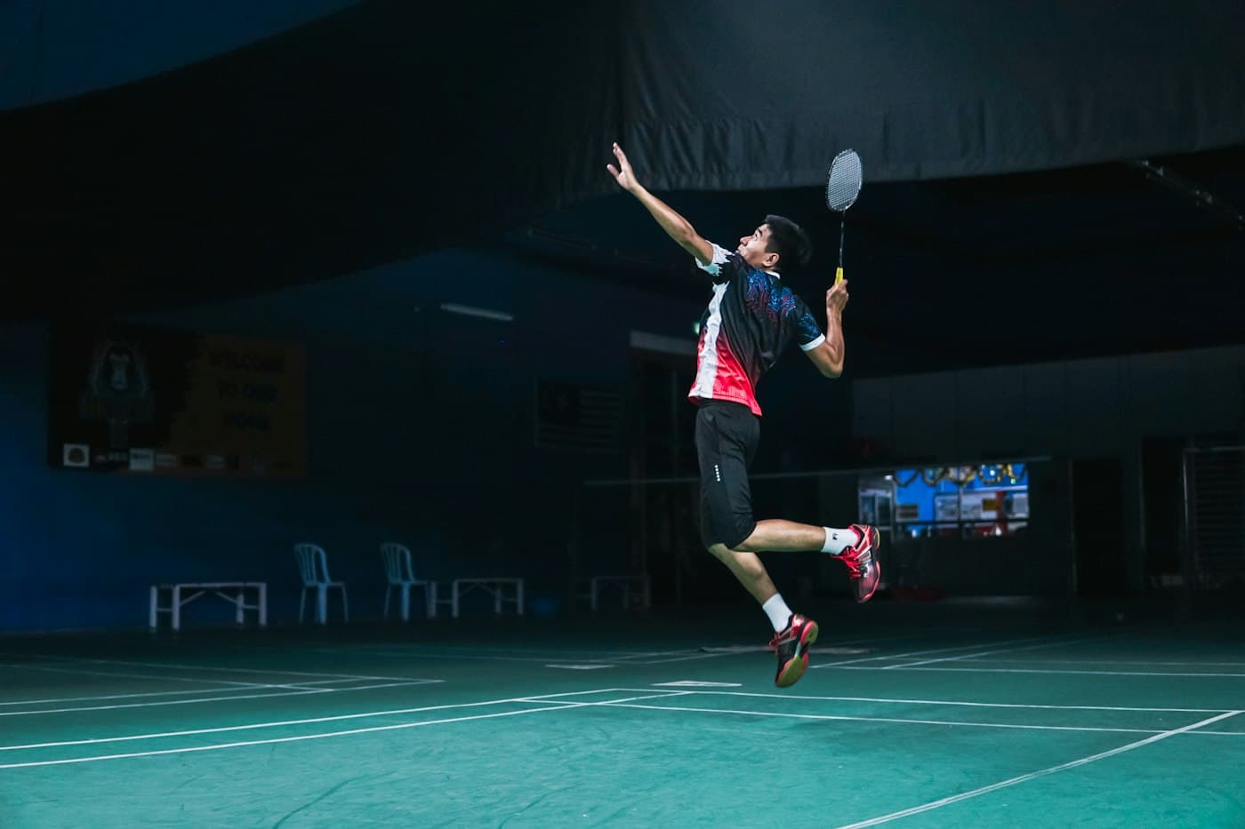 Badminton player jumping for a smash