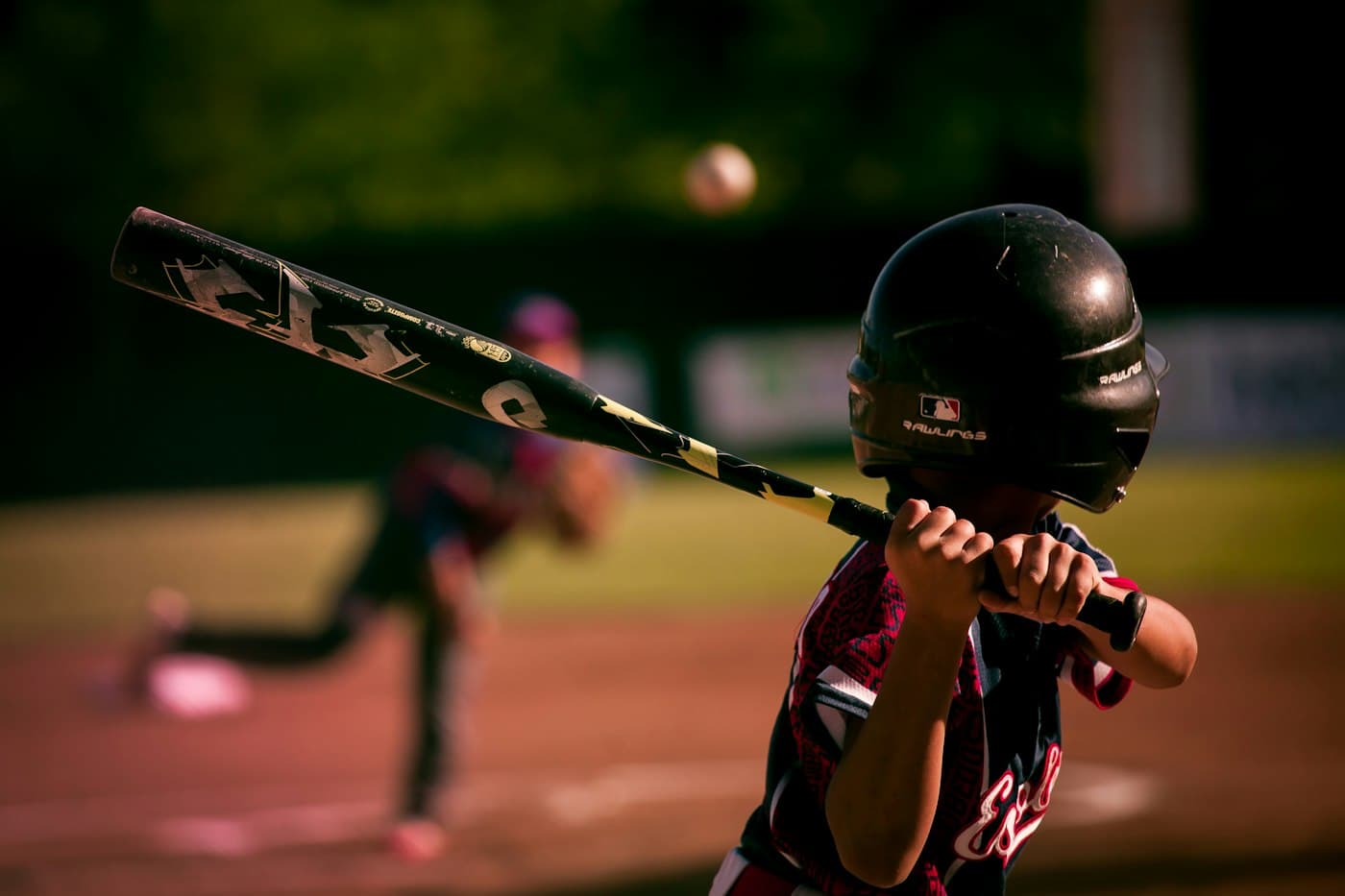 Young batter in a helmet waiting for the pitch